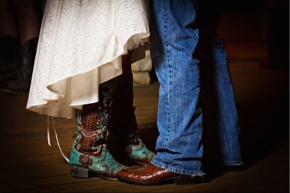 Bride and groom's showing off their western style with cowboy boots